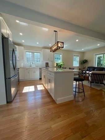 47 Bow Street Saugus, MA 01906 - Photo 26 of 31 a kitchen with stainless steel appliances granite countertop a refrigerator and a stove top oven