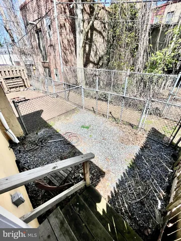 a view of a backyard with wooden fence