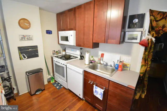 a utility room with sink dryer and washer