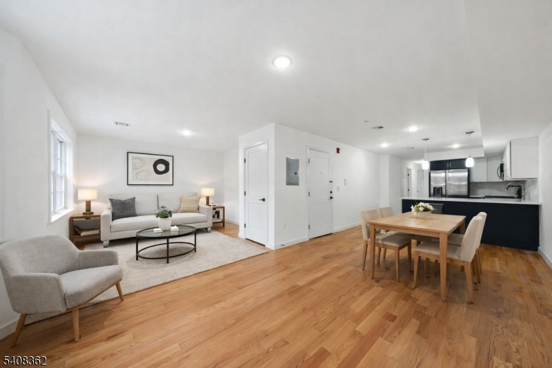 52 James Street, Unit 3 Newark, NJ 07102 - Photo 1 of 25 a living room with furniture wooden floor and a kitchen view