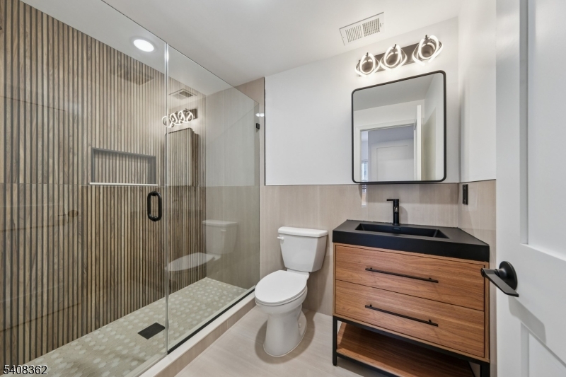 52 James Street, Unit 3 Newark, NJ 07102 - Photo 14 of 25 a bathroom with a granite countertop sink toilet and shower