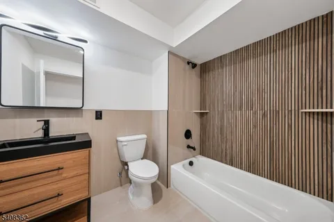 a bathroom with a toilet a sink and bathtub