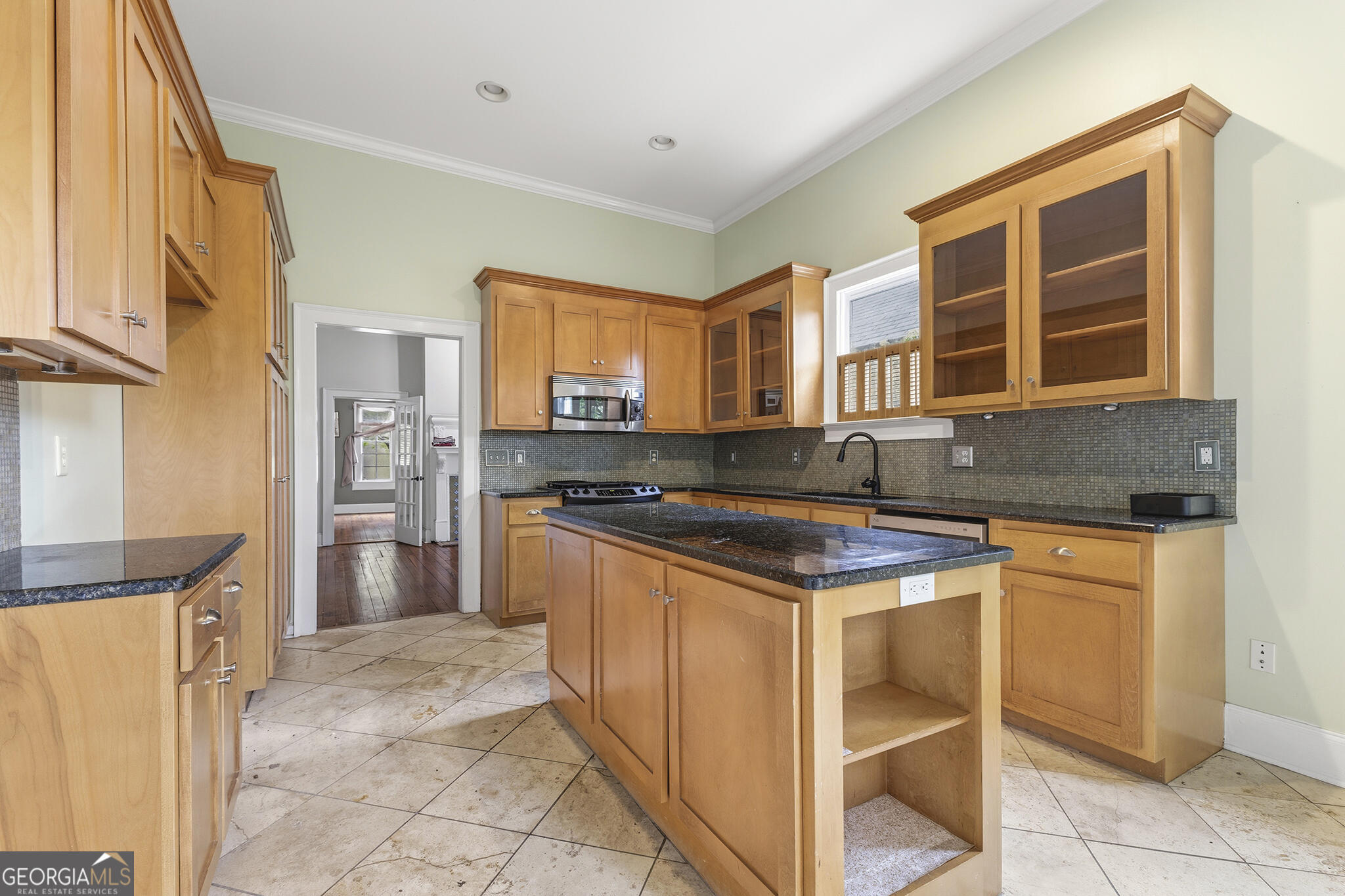 1469 Chestnut Street Macon, GA 31201 - Photo 19 of 26 a kitchen with stainless steel appliances granite countertop a stove and a refrigerator
