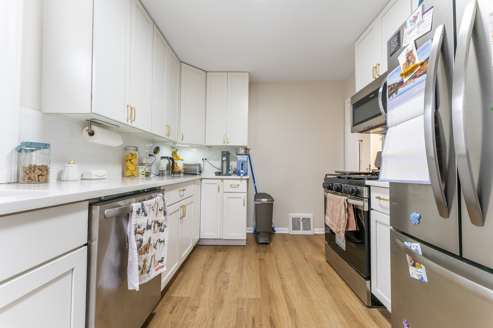 3227 Harrison Avenue Brookfield, IL 60513 - Photo 8 of 21 a kitchen with granite countertop a refrigerator a sink and wooden floor