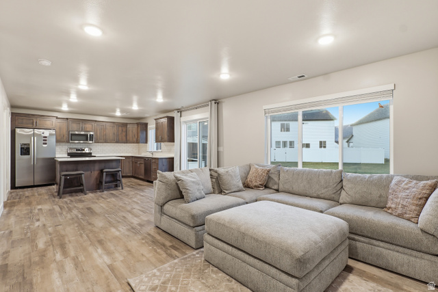 2011 Wren Circle Logan, UT 84339 - Photo 6 of 20 Living area with light wood finished floors and recessed lighting