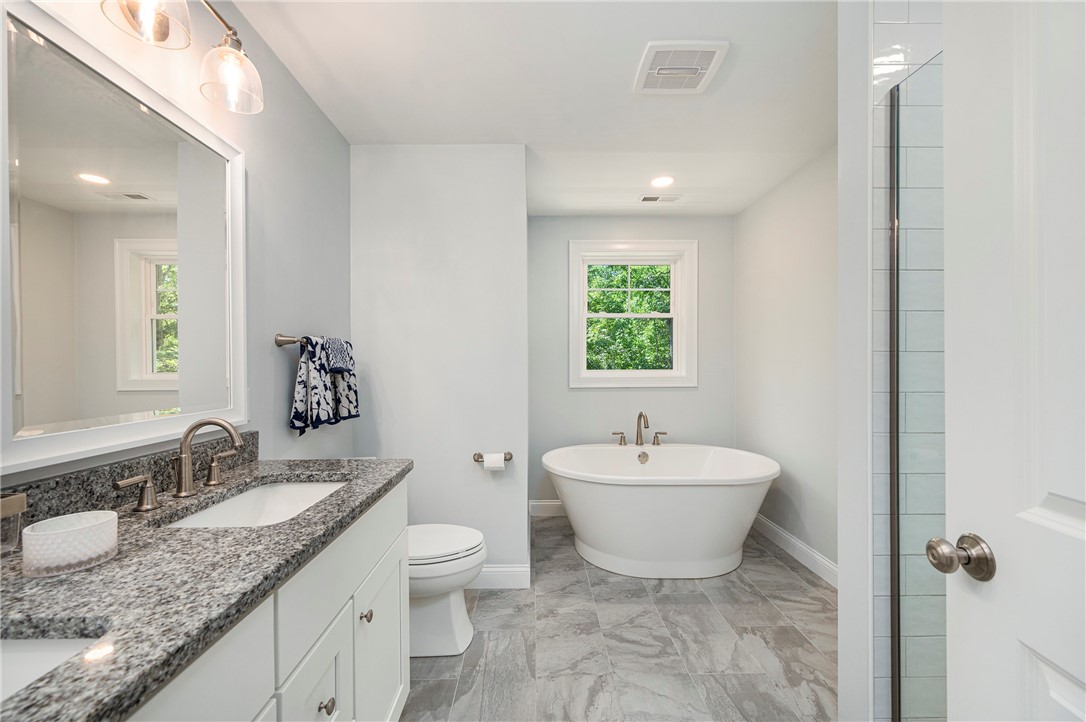 936 S Road East Greenwich, RI 02818 - Photo 18 of 31 Master bath with granite vanity and double sinks and a soaking tub