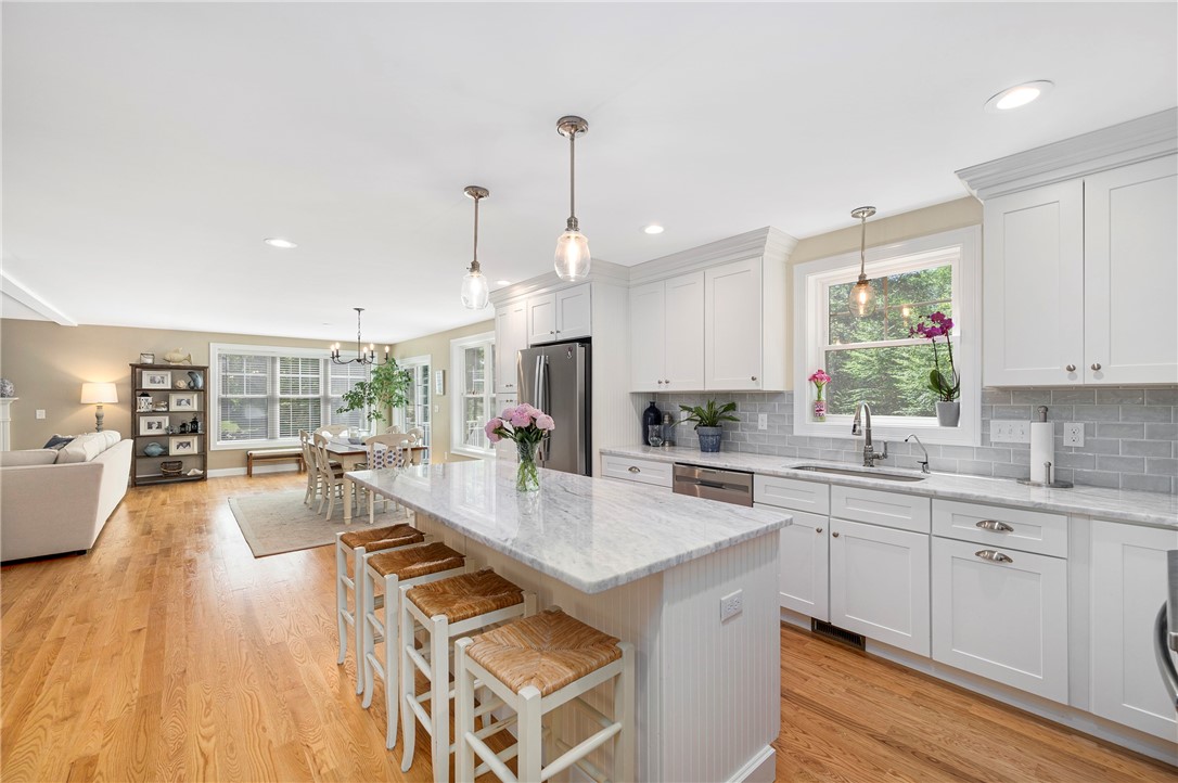 936 S Road East Greenwich, RI 02818 - Photo 8 of 31 Island seating with quartzite counters, subway tile backsplash and stainless appliances.
