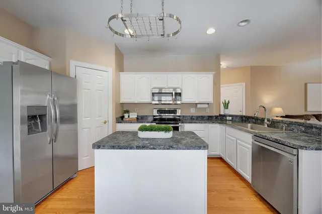 a kitchen with center island and stainless steel appliances