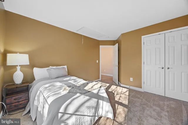 a bedroom with a bed and lamp