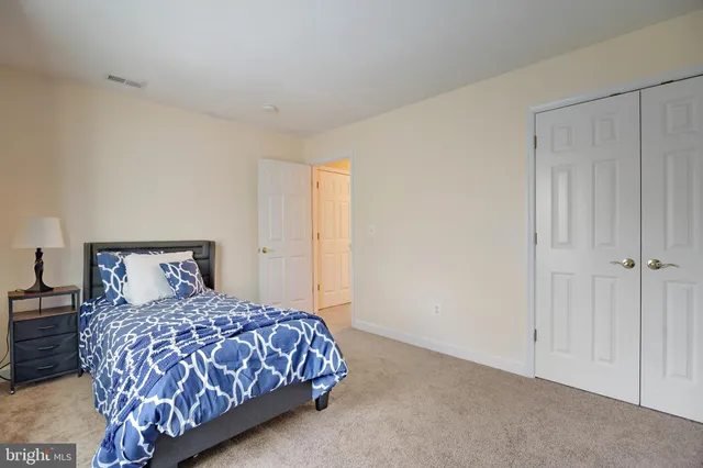 a bedroom with a large bed and a night stand