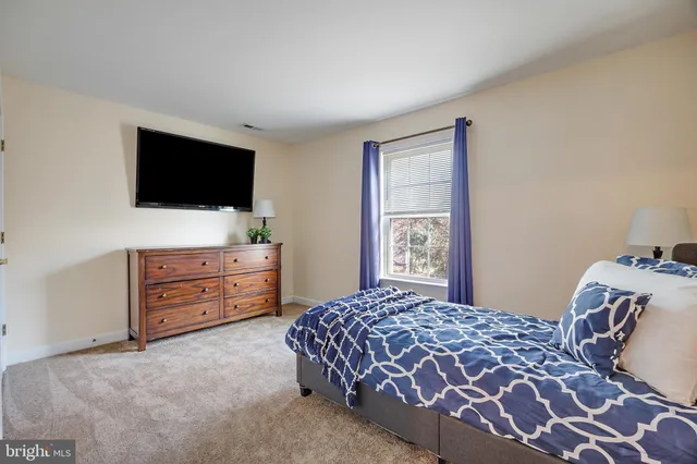 a bedroom with a bed and a flat screen television