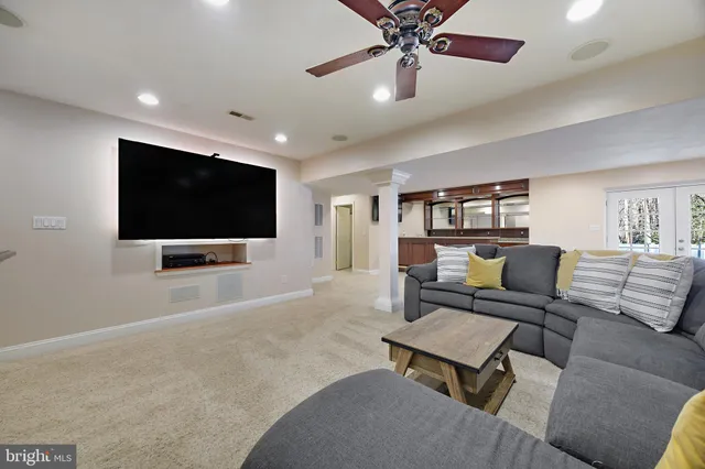 a living room with furniture and a ceiling fan