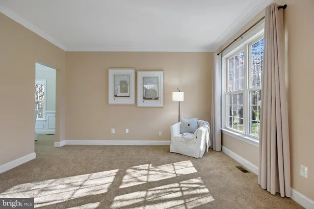 a spacious bedroom with a bed and glass window
