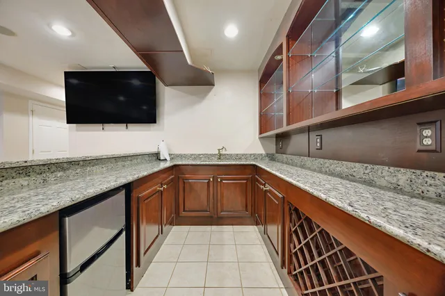 a kitchen with granite countertop a sink and a stove top oven