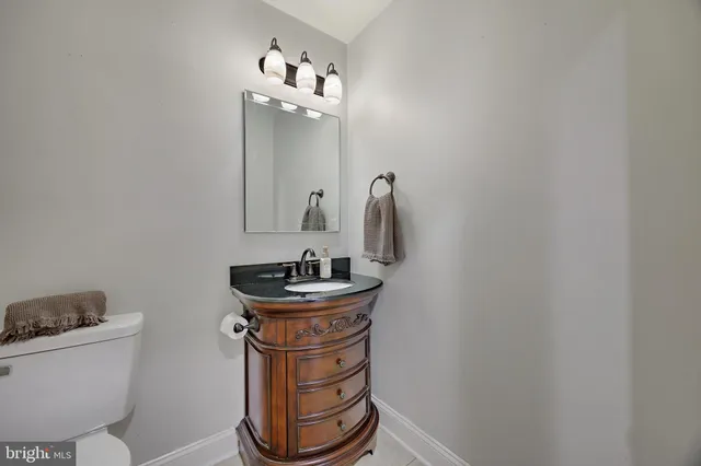a white toilet sitting next to a small sink