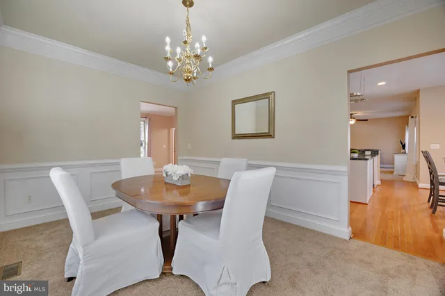 a view of a dining room with furniture and chandelier