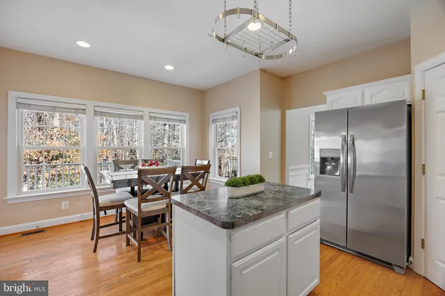 a kitchen with center island and stainless steel appliances