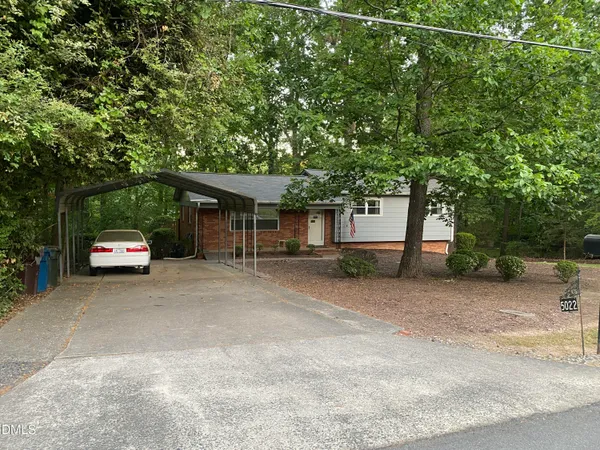 a view of a car parked in front of a house