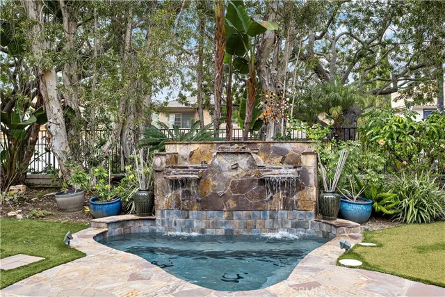a view of a water fountain in front of the house