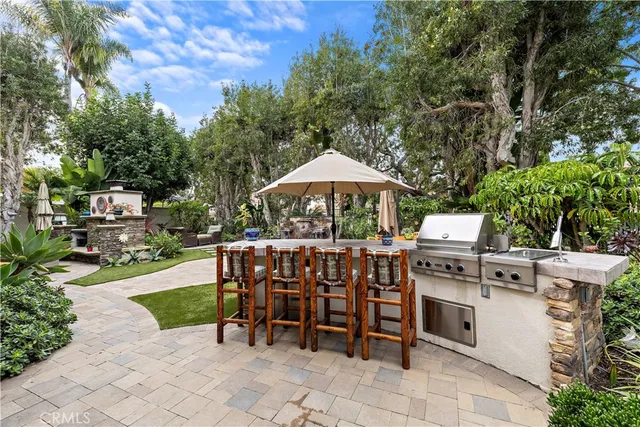 a view of a chairs and table in backyard