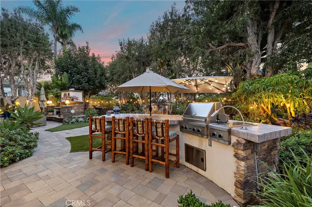 a view of a patio with furniture and a fire pit