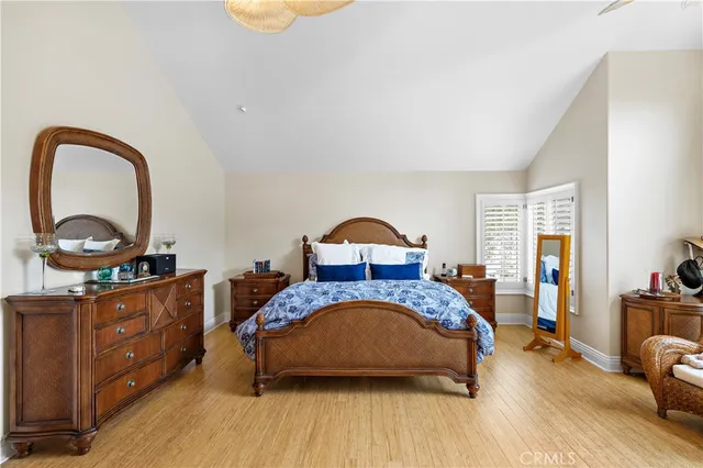 a bedroom with a bed and a dresser next to a window