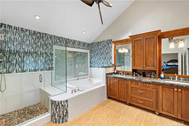 a bathroom with a tub sink and mirror