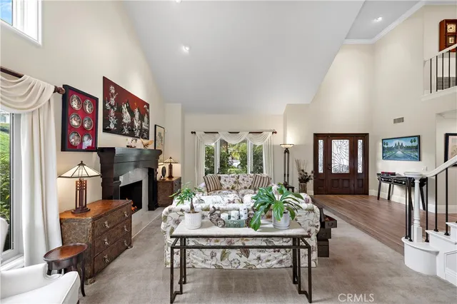 a living room with furniture fireplace and dining room
