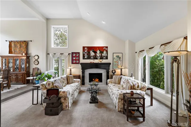 a living room with furniture large window and a fireplace