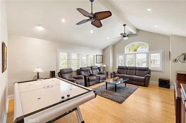 a living room with furniture ceiling fan and a large window
