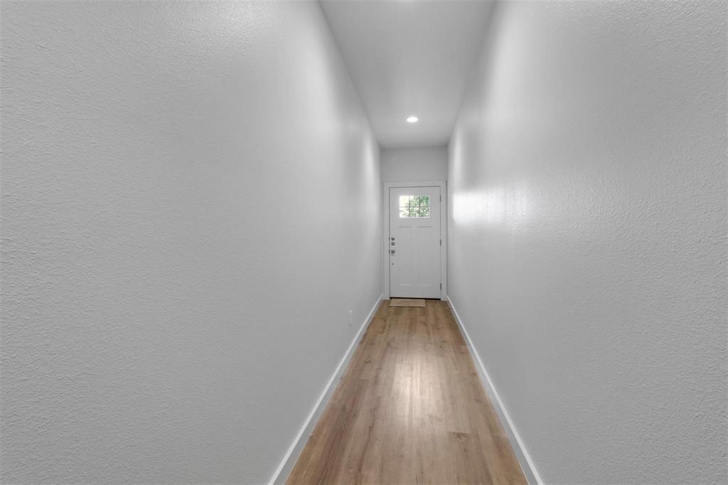 312 East Shepherd Street, Unit 312 Denison, TX 75021 - Photo 7 of 15 a view of a hallway with wooden floor
