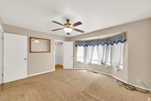 8029 Angel Street Sandy, UT 84070 - Photo 11 of 21 Carpeted room featuring a bay window, ceiling fan with integrated lighting, and neutral wall tones