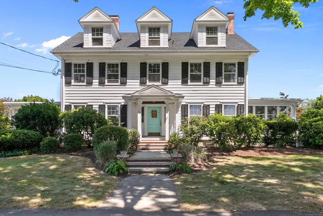 a front view of a residential houses with yard