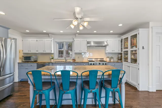 a large kitchen with a table and chairs