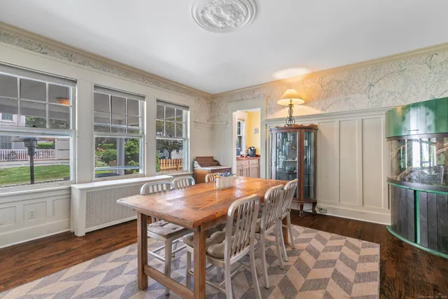 a dining room with furniture and wooden floor