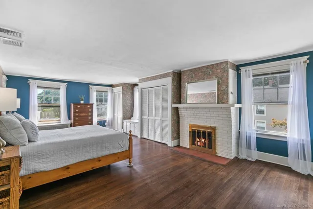 a bedroom with a bed and a fireplace