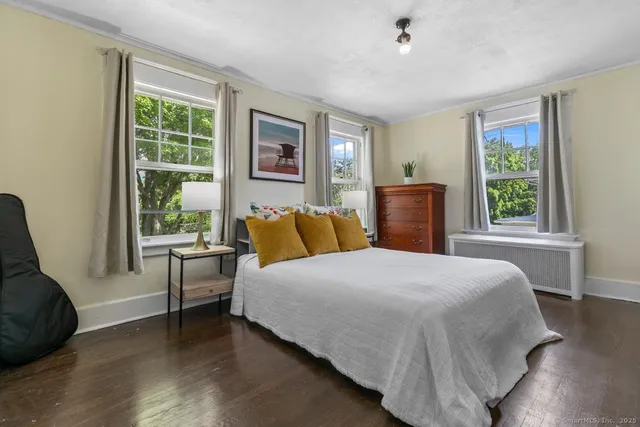 a bedroom with a large bed and a couch