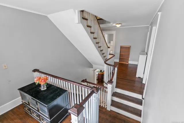 a living room with stairs and a chandelier