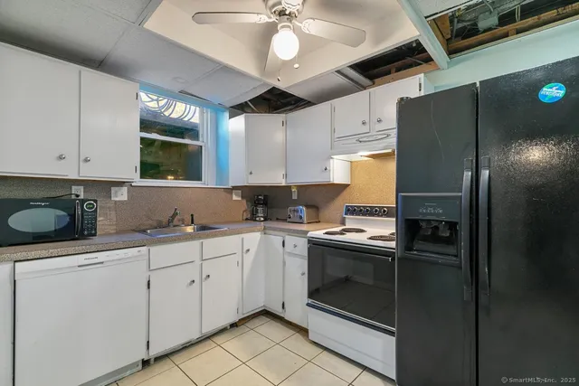 a kitchen with a sink stainless steel appliances and cabinets