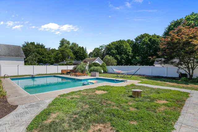 a view of an house with swimming pool and yard