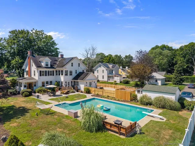an aerial view of a house with swimming pool patio and outdoor seating
