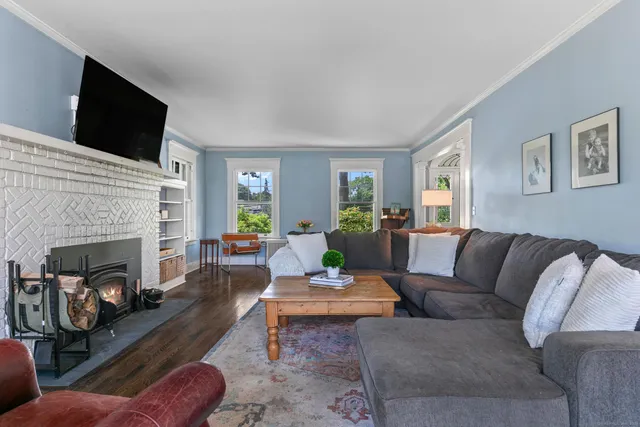 a living room with furniture fireplace and a flat screen tv