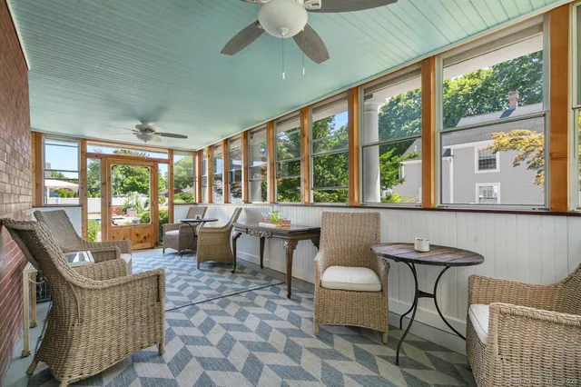 a living room with furniture and a floor to ceiling window