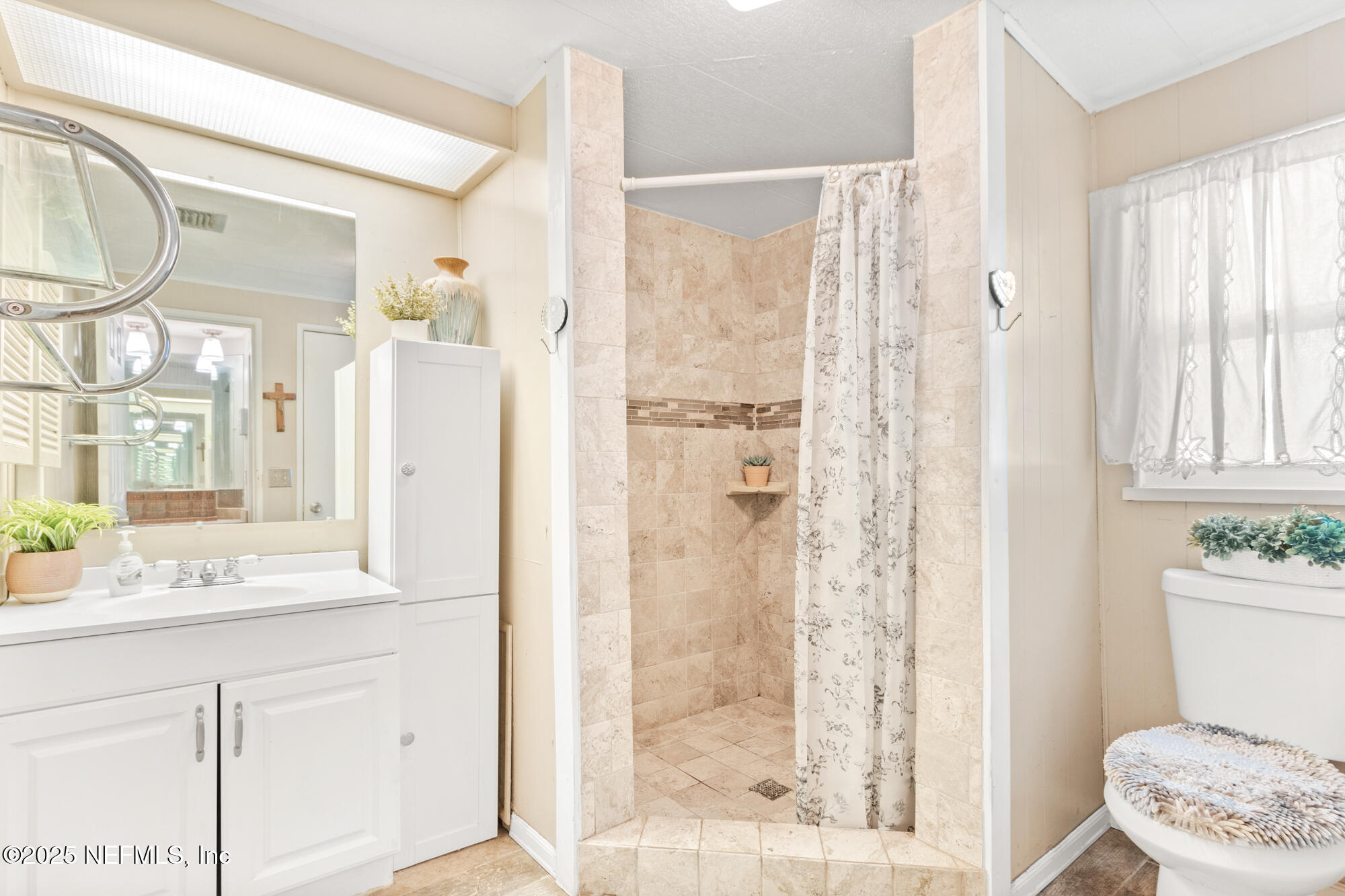 106 Deltona Boulevard St. Augustine, FL 32086 - Photo 12 of 36 a bathroom with a granite countertop sink toilet and shower
