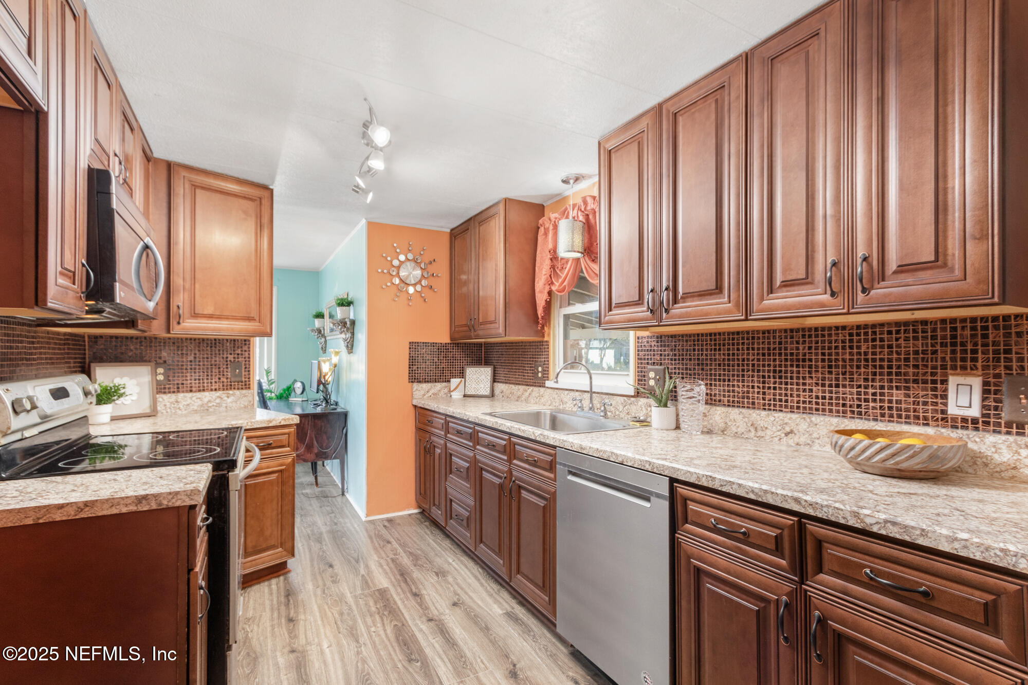 106 Deltona Boulevard St. Augustine, FL 32086 - Photo 16 of 36 a kitchen with a sink a stove cabinets and wooden floor