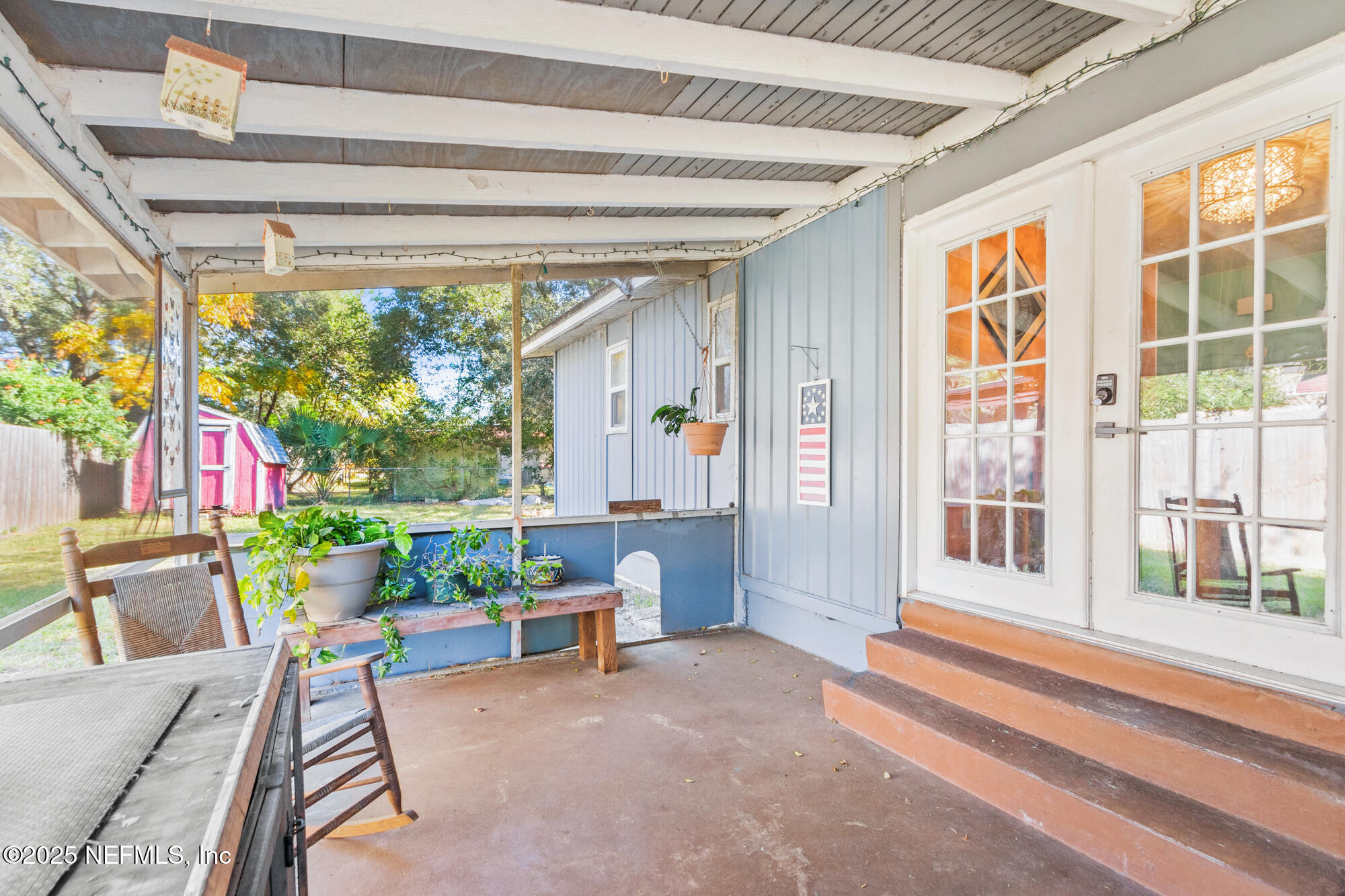 106 Deltona Boulevard St. Augustine, FL 32086 - Photo 19 of 36 a porch area with table and chairs