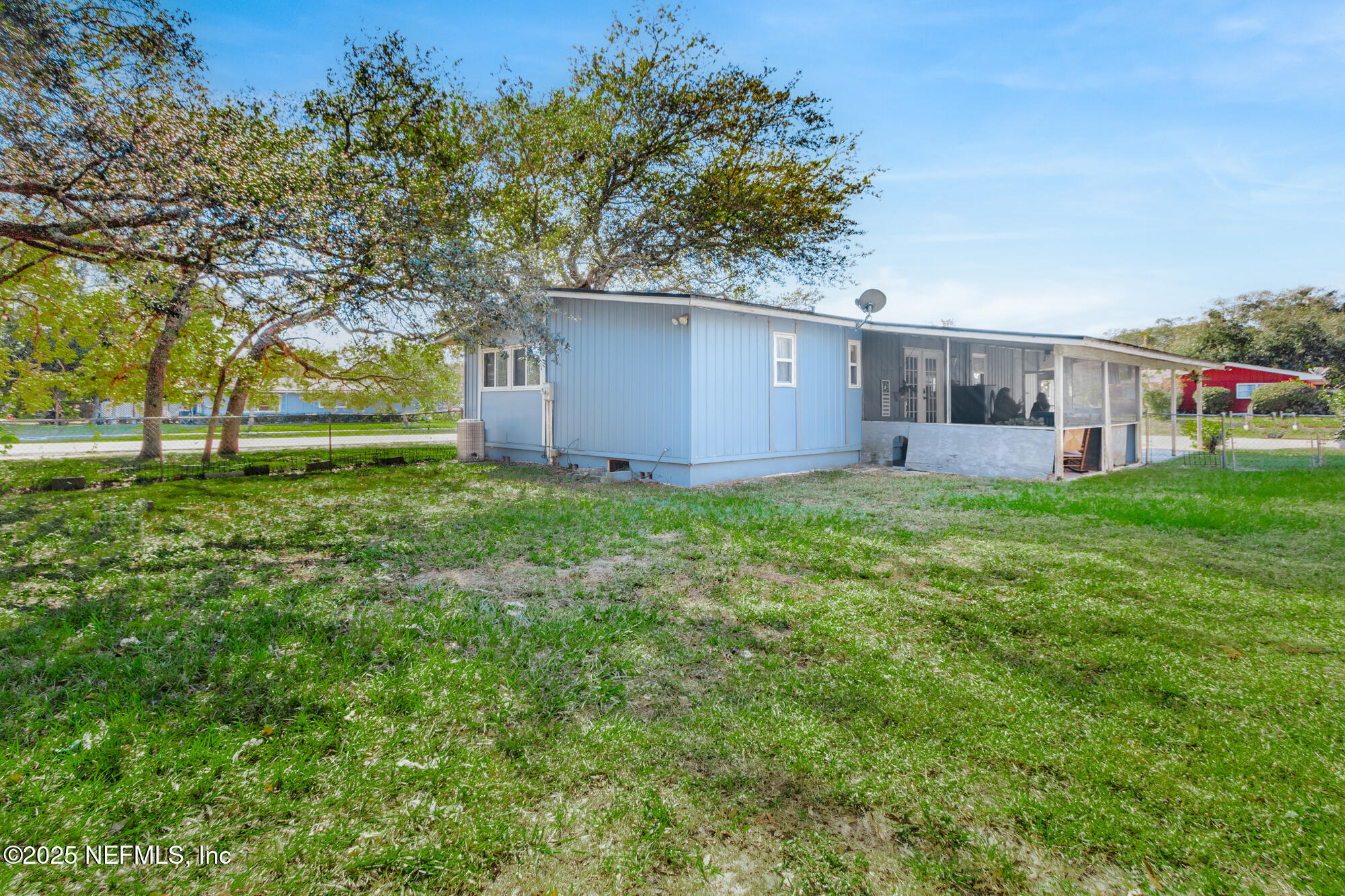 106 Deltona Boulevard St. Augustine, FL 32086 - Photo 26 of 36 a view of a house with a yard and sitting area