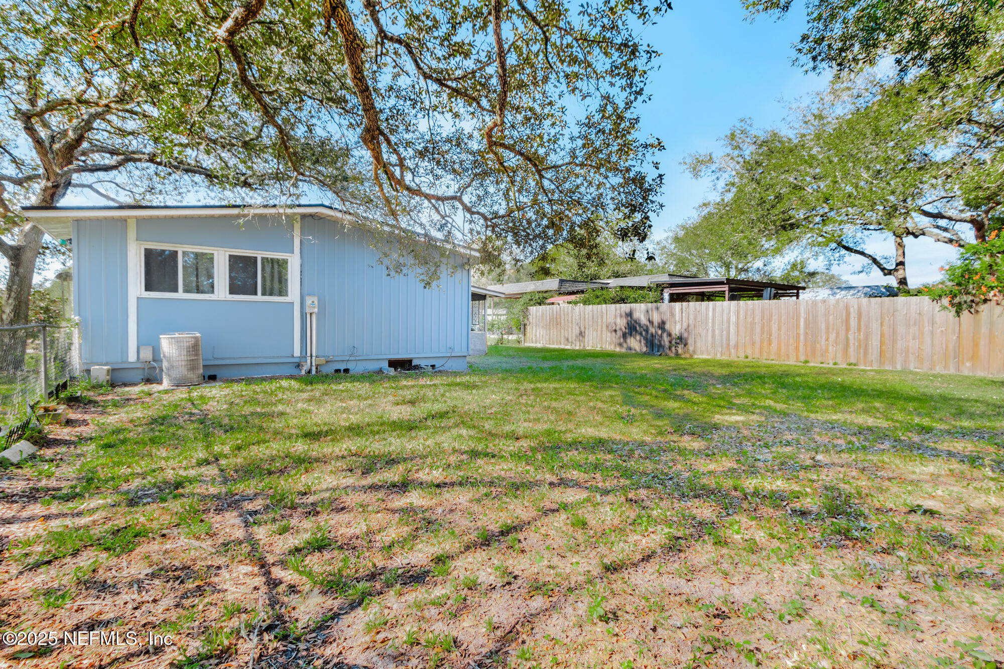 106 Deltona Boulevard St. Augustine, FL 32086 - Photo 27 of 36 a backyard of a house with table and chairs