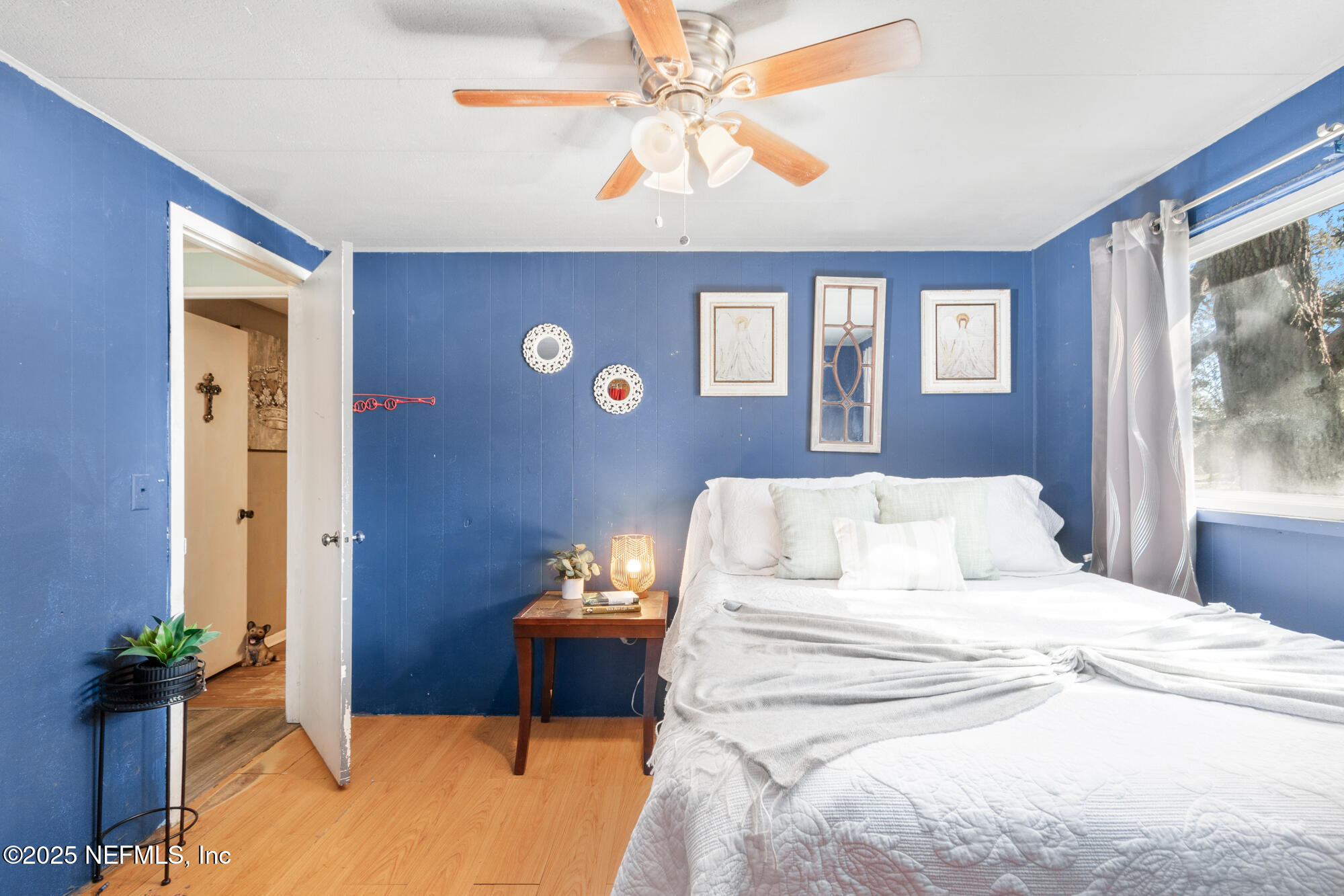 106 Deltona Boulevard St. Augustine, FL 32086 - Photo 7 of 36 a bedroom with a bed and a chandelier