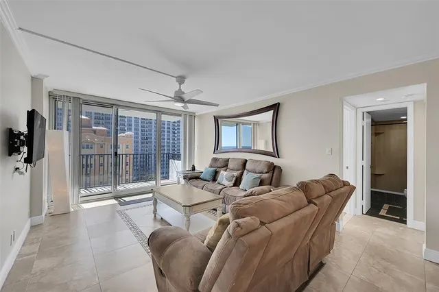 a living room with furniture large windows and a rug